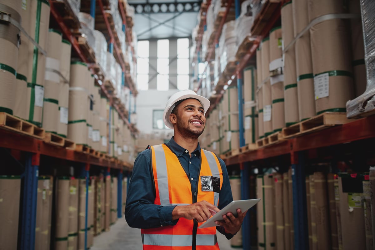 Warehouse worker scanning stock on shelves